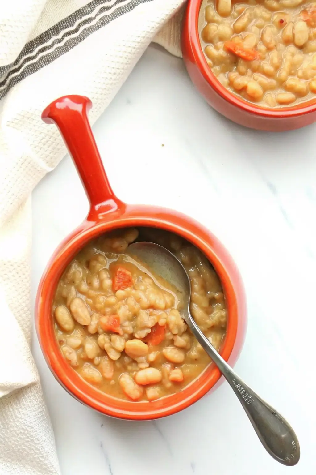 Finished lima bean recipe served in a rustic bowl with cornbread