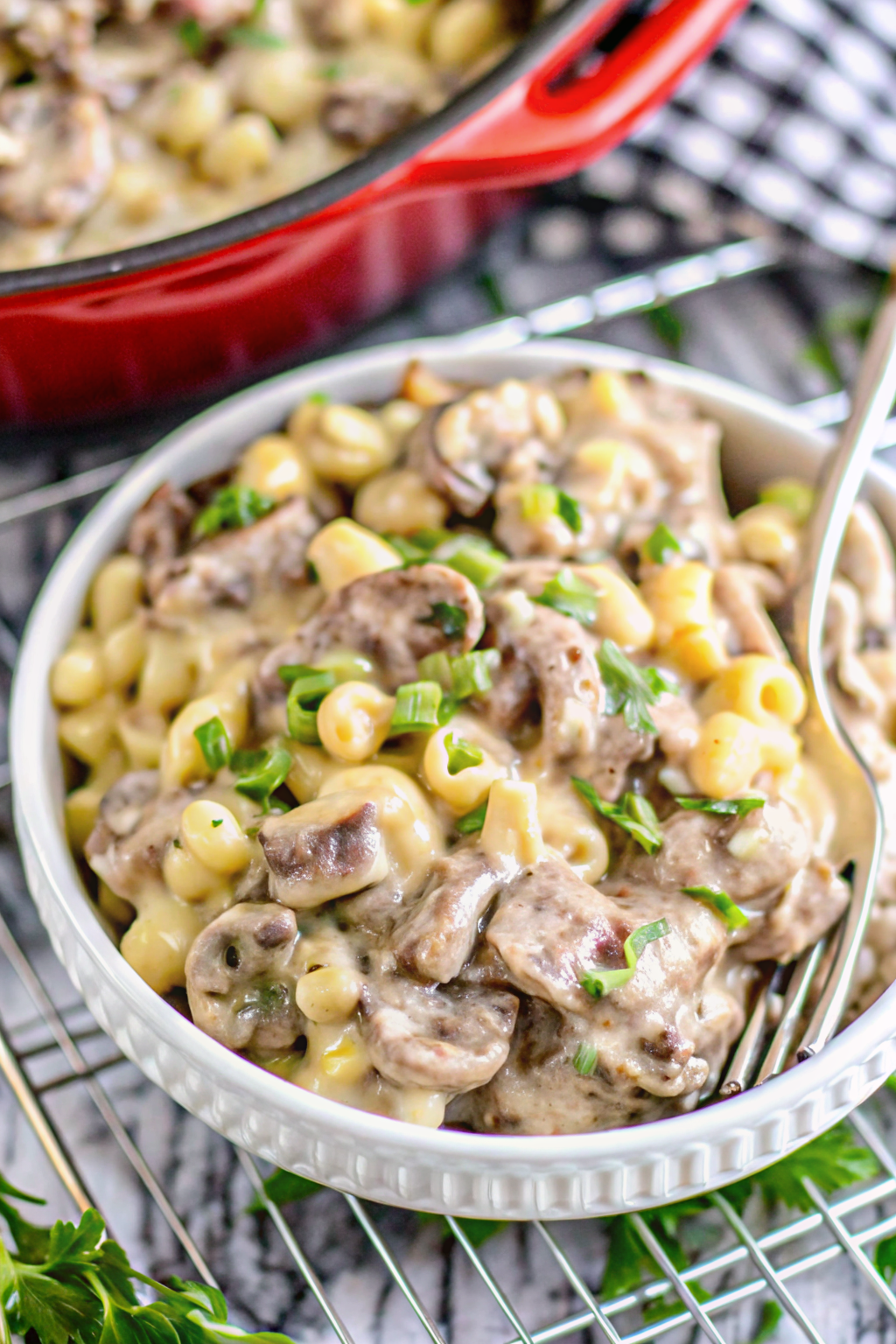 Bowl of creamy cheesesteak mac and cheese with steak and peppers
