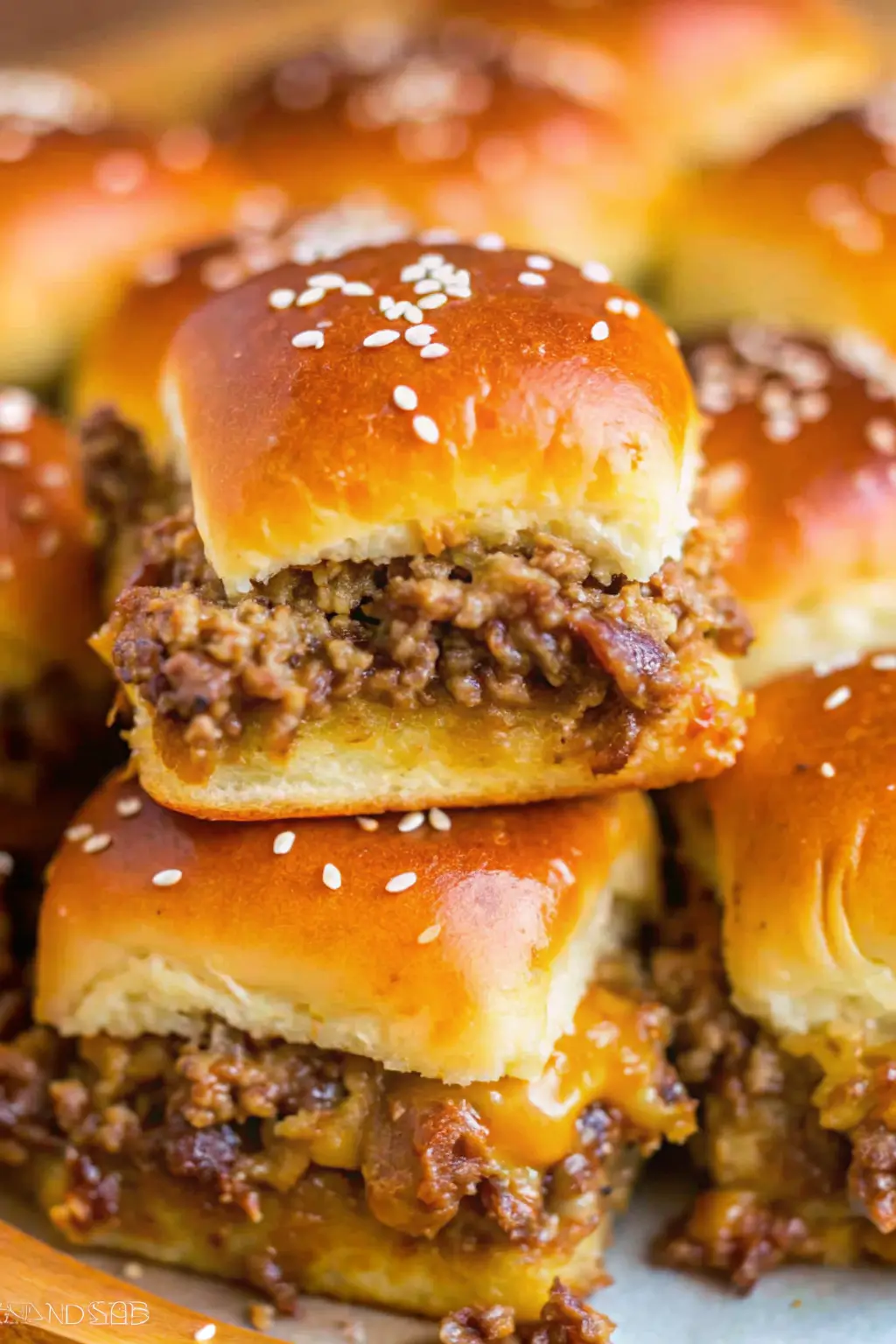 Mini sliders burger served on a tray with melted cheese, juicy patties, and soft toasted buns