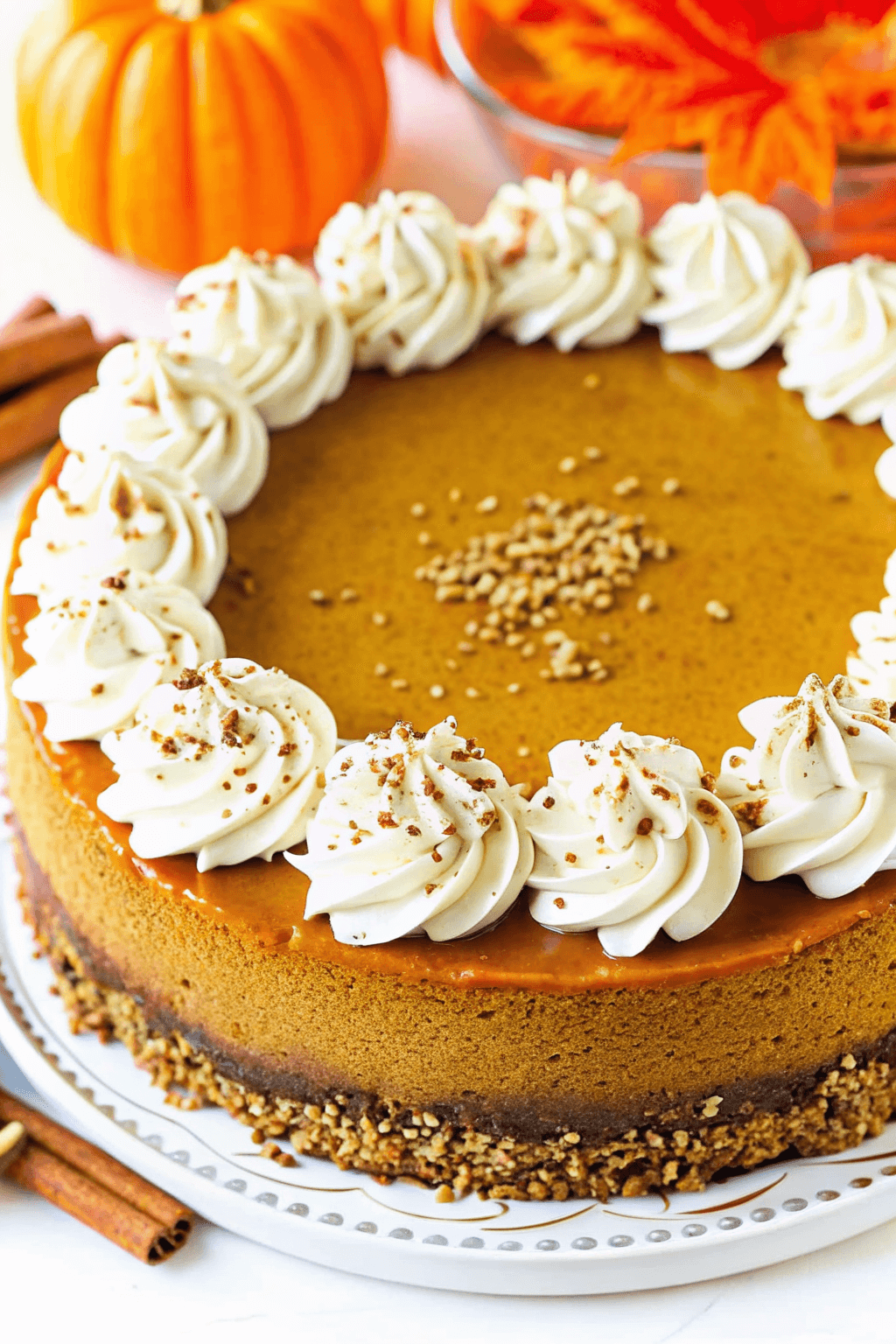 Delicious creamy pumpkin cheesecake topped with whipped cream and cinnamon