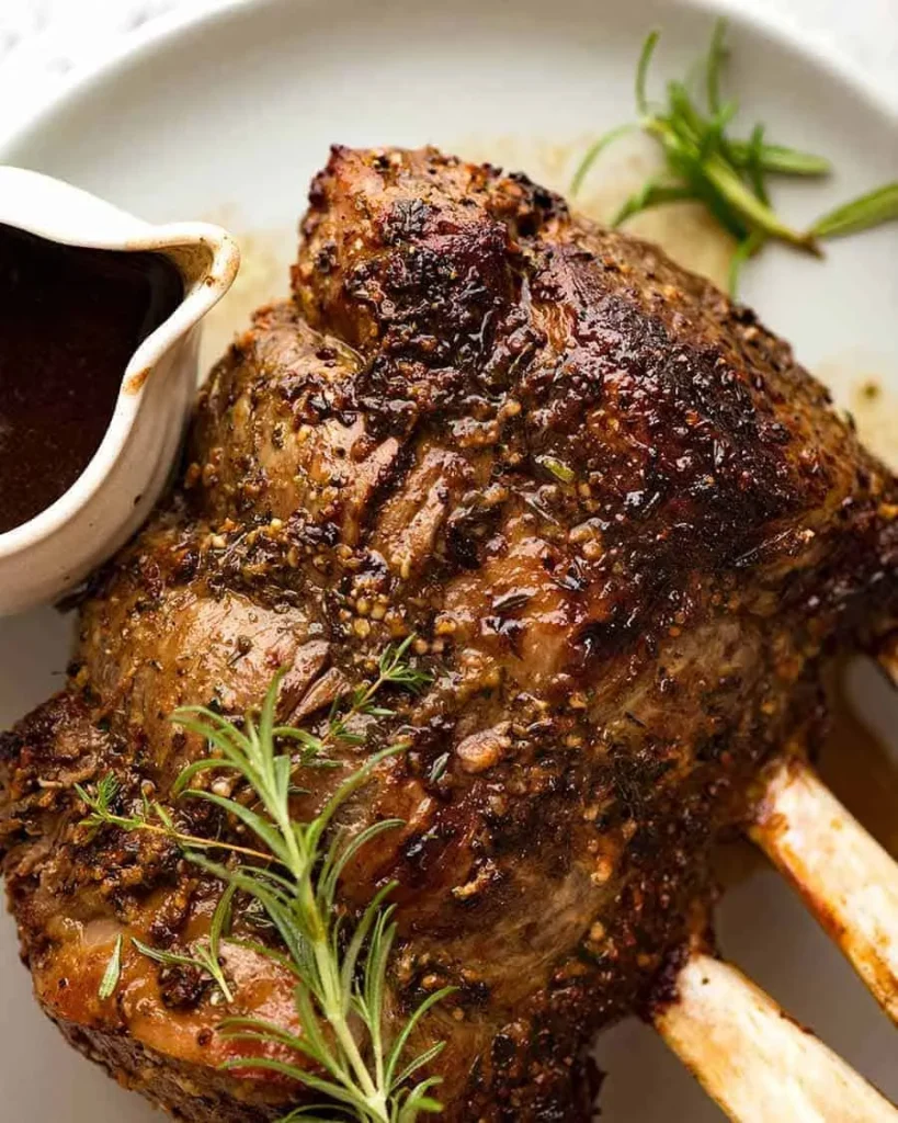 A close up of the dark brown crust on a cooked prime rib roast.