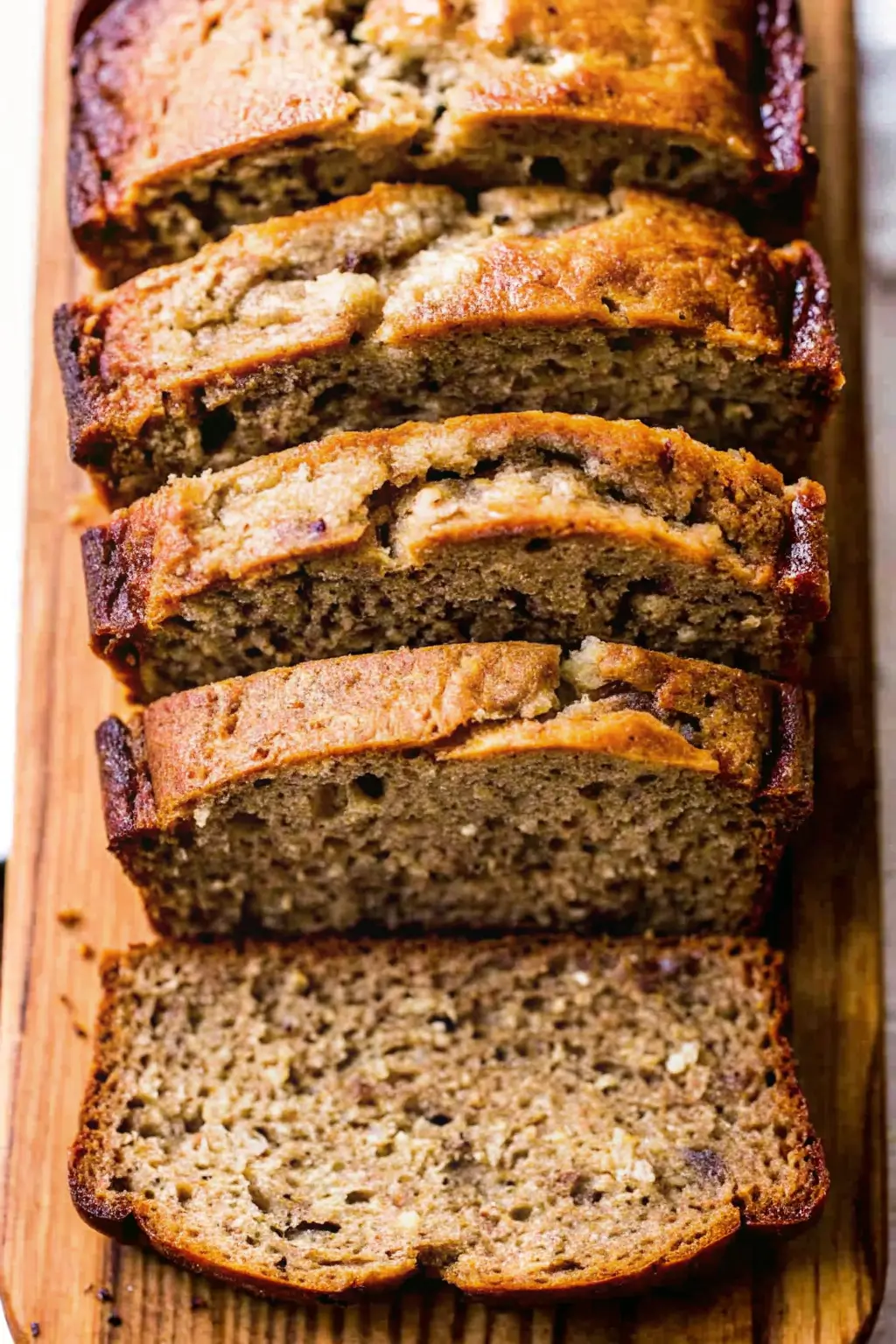 Homemade banana bread loaf on wooden board