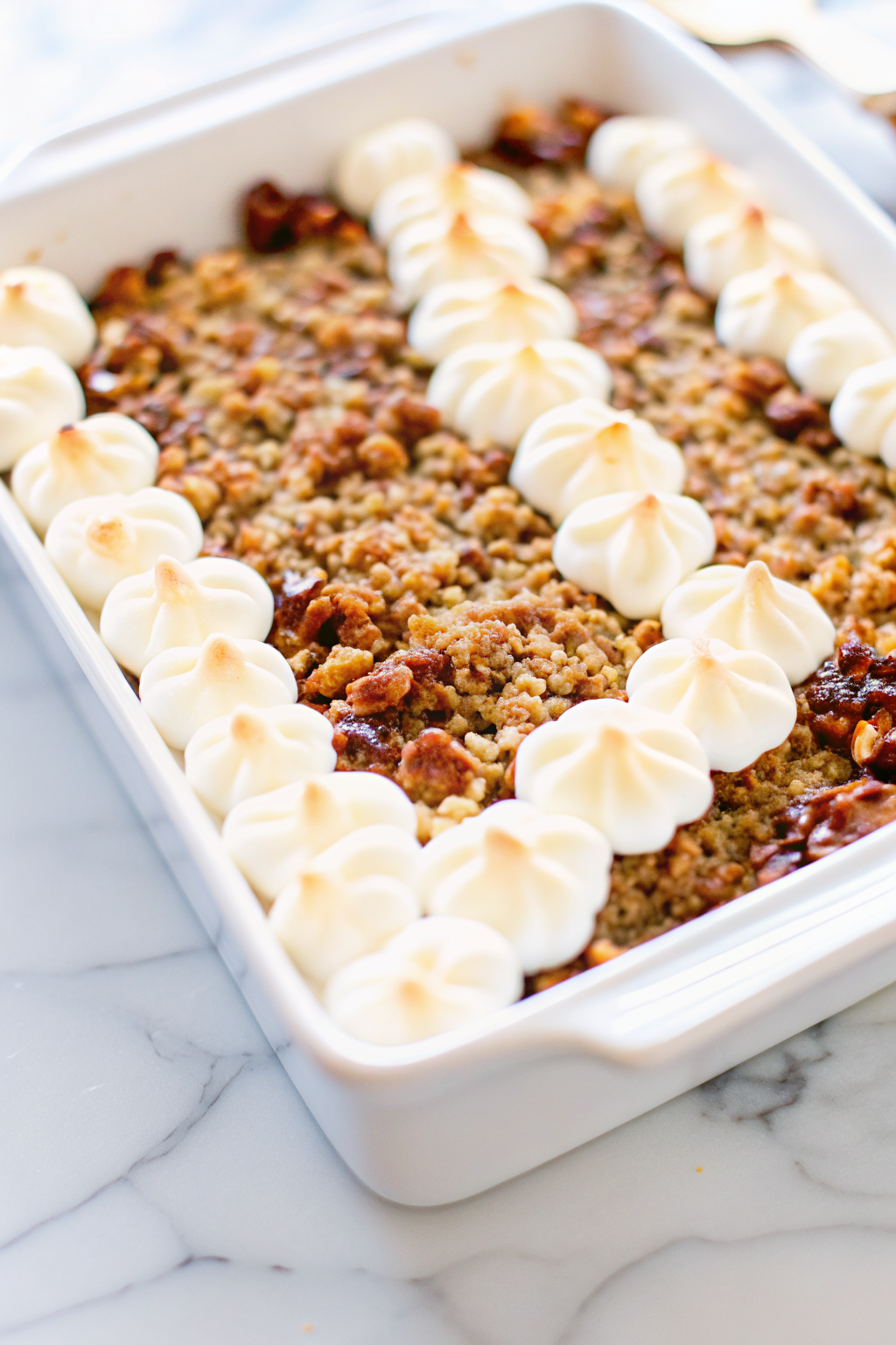 Sweet Potato Casserole topped with golden marshmallows and crunchy pecans in a baking dish