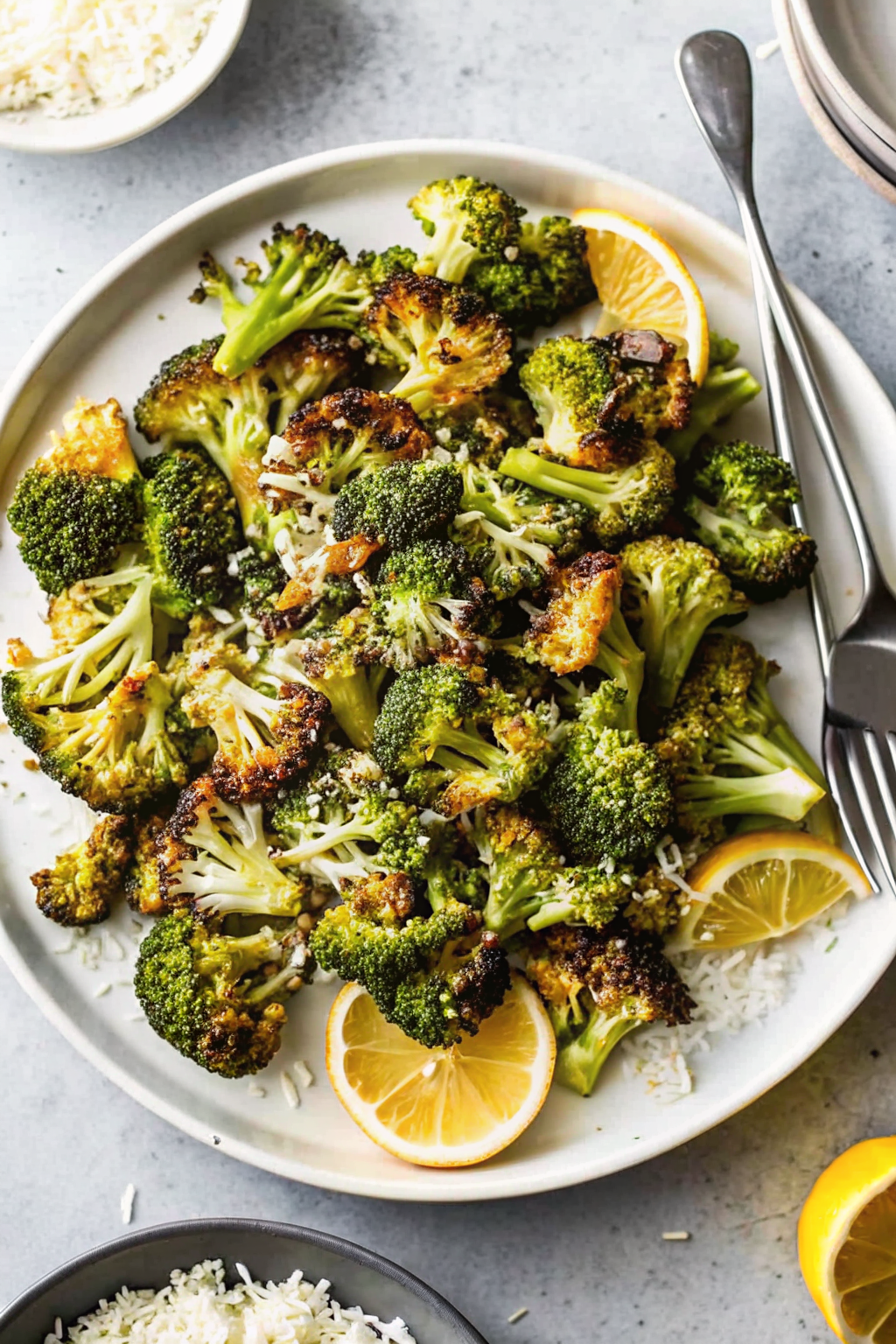 Fresh broccoli florets being dried on a kitchen towel before roasting