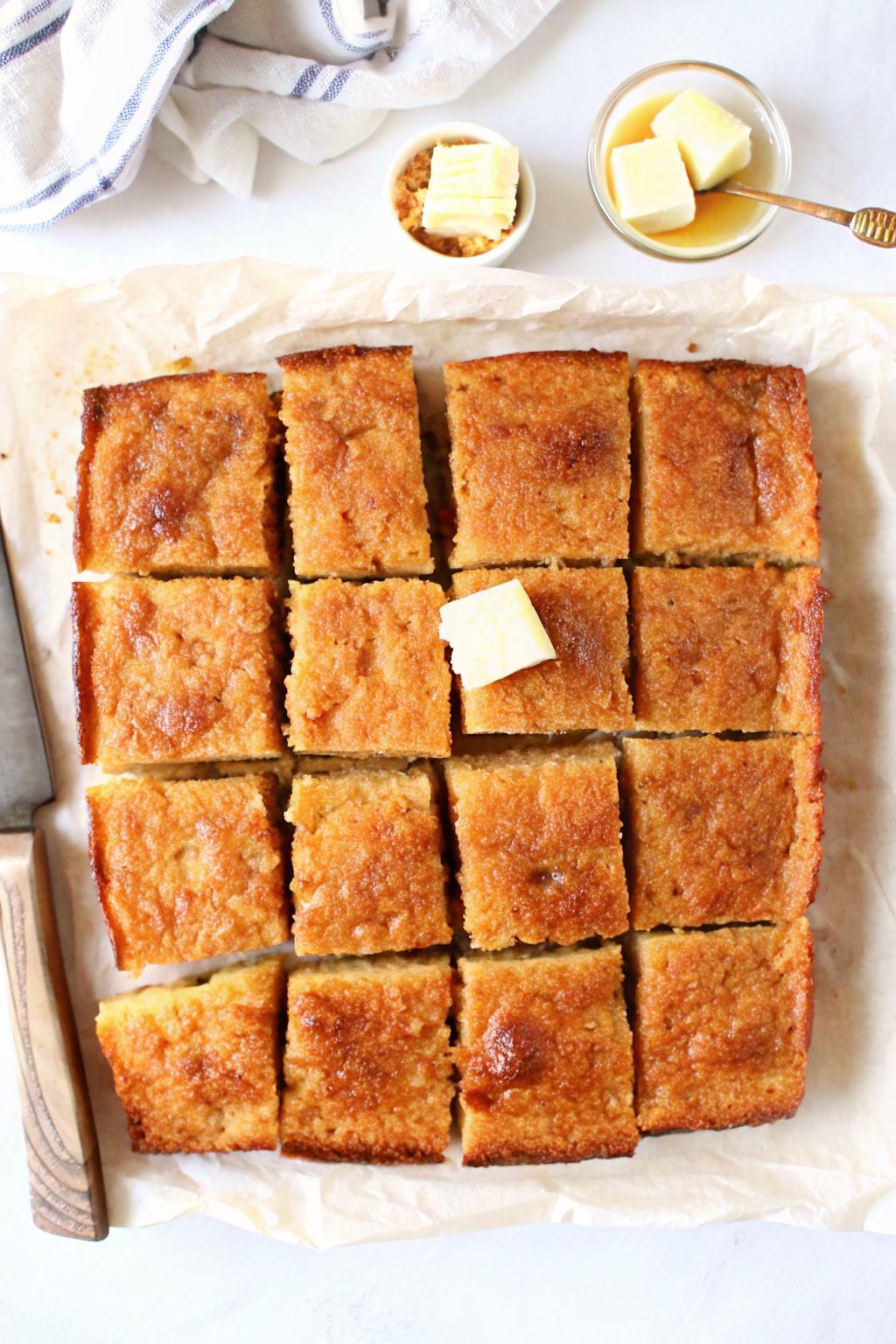 Pouring thick yellow cornbread batter into a prepared skillet.