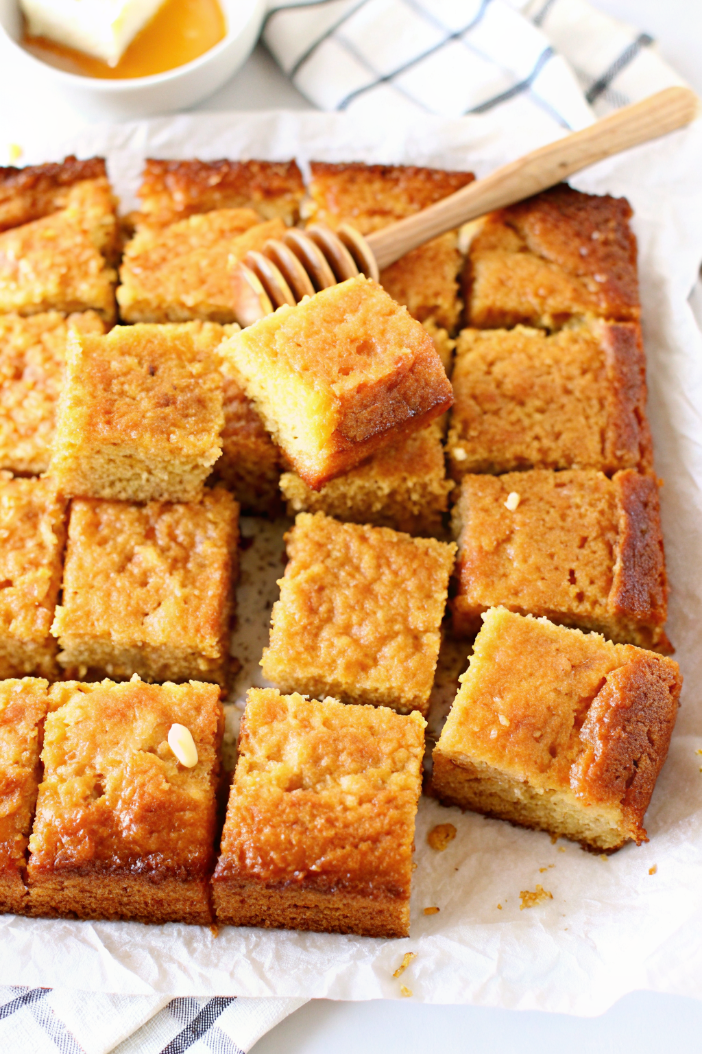 Freshly baked cast iron cornbread cooling in a skillet on a rustic wooden table