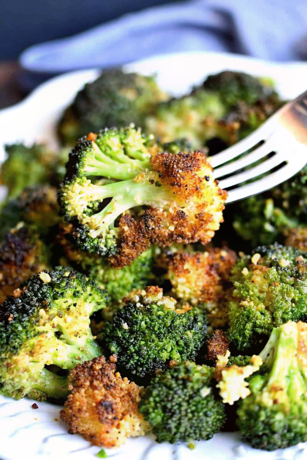 A baking sheet filled with crispy parmesan roasted broccoli fresh from the oven