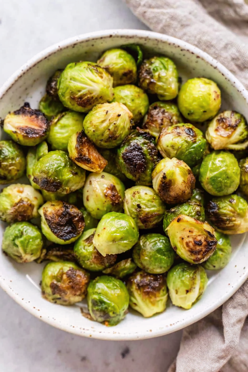 A sheet pan filled with hot, crispy roasted Brussels sprouts.