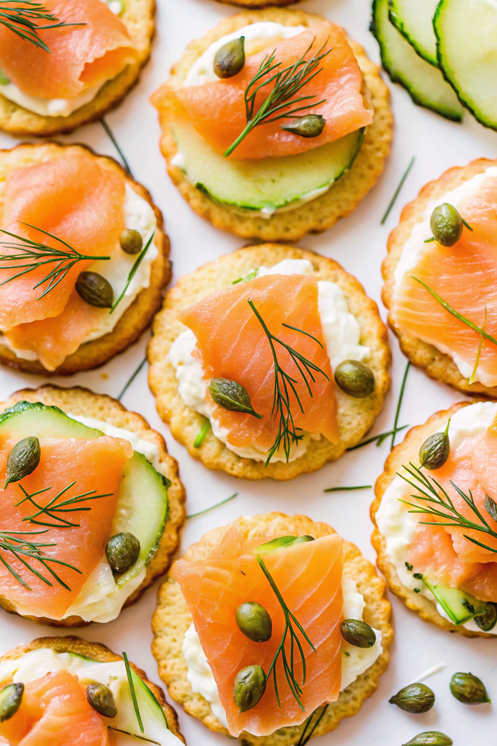Elegant smoked salmon bites with cream cheese and dill on a slate platter.