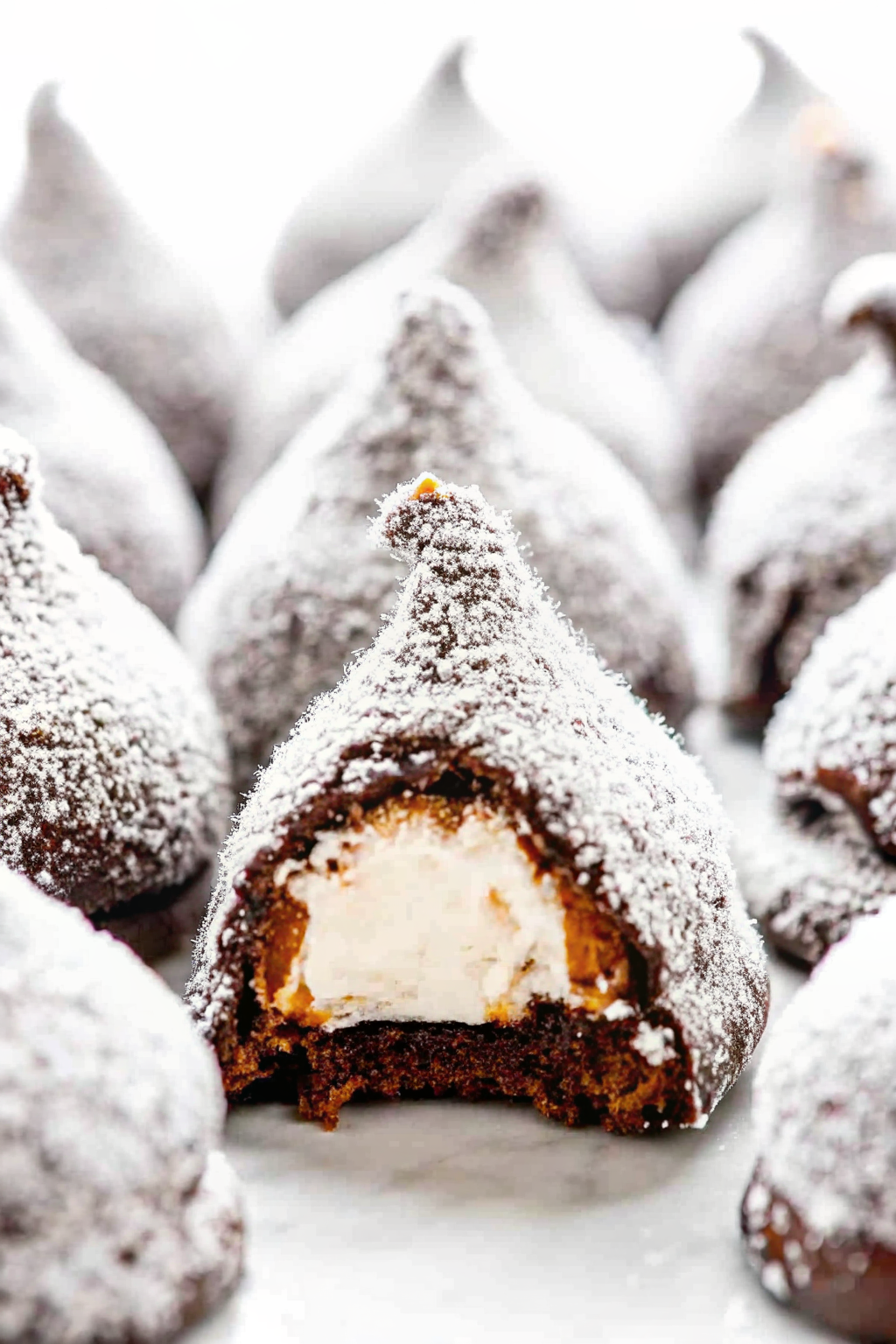 A festive pyramid of coconut-covered marshmallow snowballs on a silver platte
