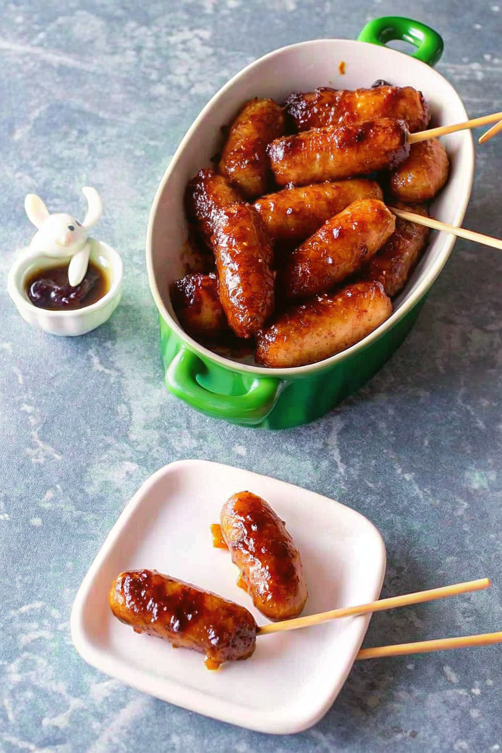 A slow cooker filled with simmering sausages in a rich brown sauce