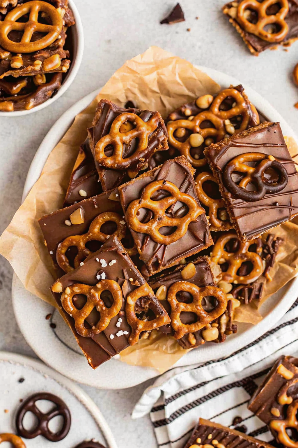 Warm salted caramel sauce being poured over baked soft pretzel bites