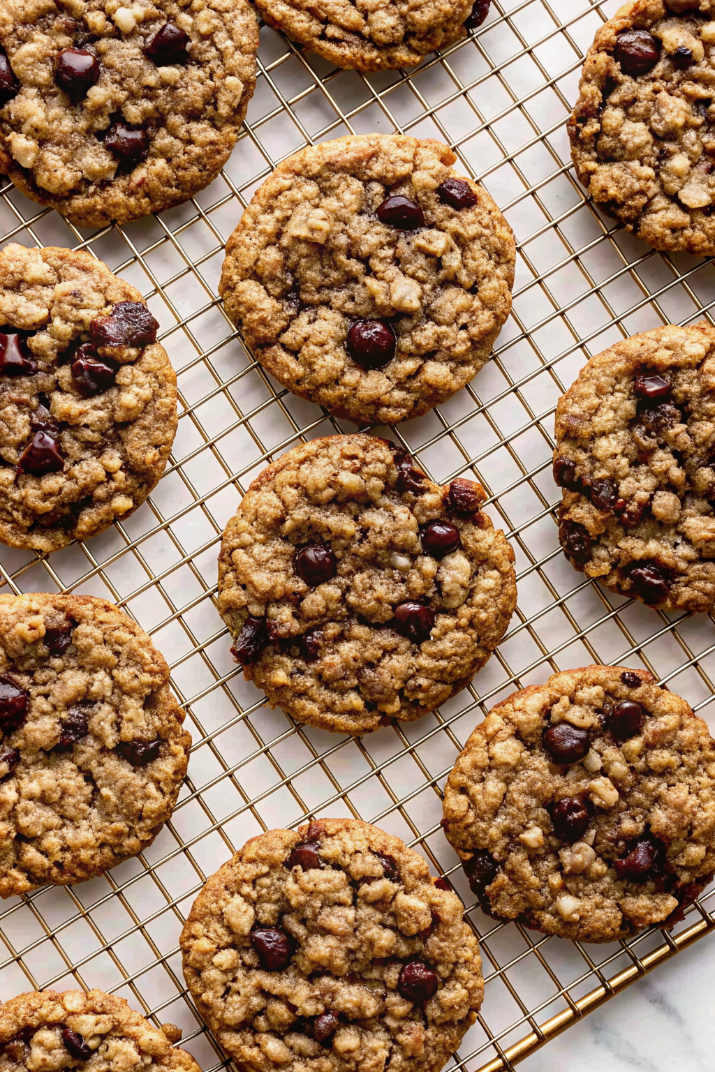 A stack of soft and chewy Oatmeal Cookies next to a glass of milk