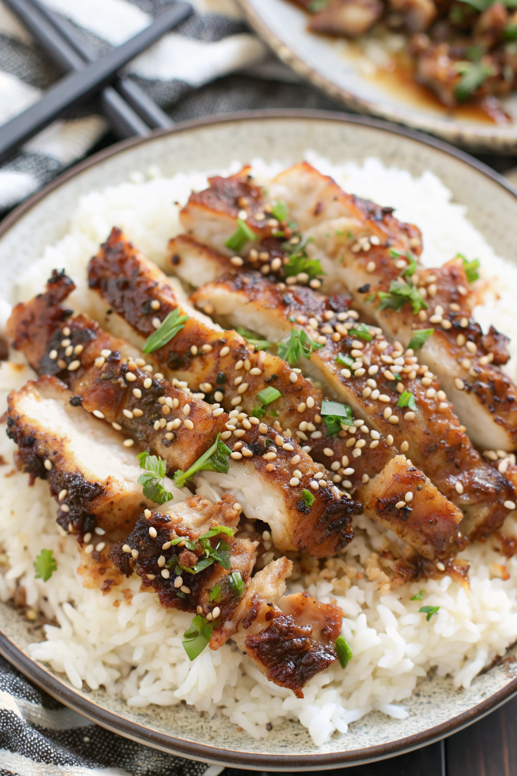 Pouring soy glaze over searing chicken thighs in a hot skillet
