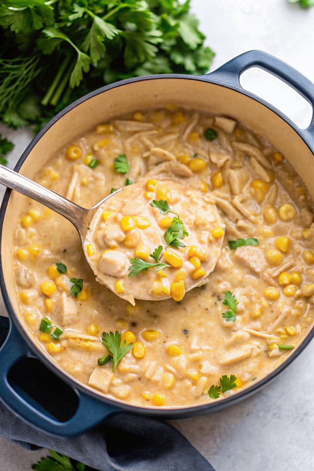 White chicken chili simmering in a Dutch oven pot